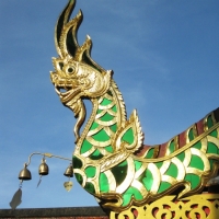 The Naga decoration in colored mirror on the roof top of the building at Doi Suthep Temple. www.chiangmaitourcenter.com